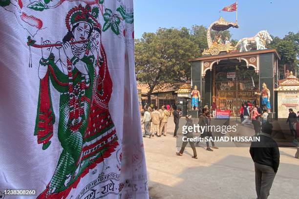 In this photograph taken on February 5 people stand outside the entrance of Shri Krishna Janmasthan temple in Mathura in India's Uttar Pradesh state....
