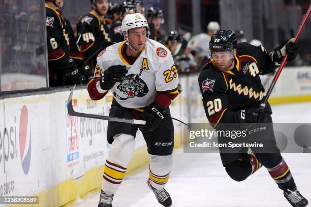 Cleveland Monsters center Justin Scott prepares to check Chicago Wolves right wing Stefan Noesen into the boards during the first period of the...