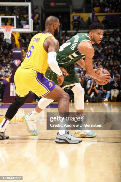 Giannis Antetokounmpo of the Milwaukee Bucks handles the ball during the game as LeBron James of the Los Angeles Lakers plays defense on February 8,...