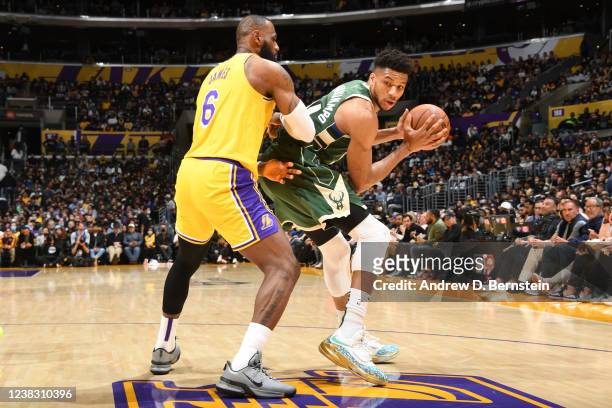 Giannis Antetokounmpo of the Milwaukee Bucks handles the ball during the game as LeBron James of the Los Angeles Lakers plays defense on February 8,...