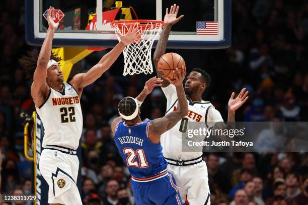 JaMychal Green and Zeke Nnaji of the Denver Nuggets defend Cam Reddish of the New York Knicks in the third quarter at Ball Arena on February 8, 2022...