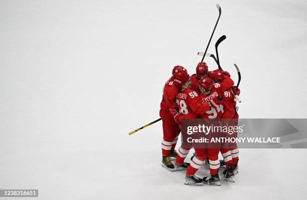 Russian Olympic Committee's Anton Slepyshev celebrates with teammates after scoring a goal against Switzerland during their men's preliminary round...