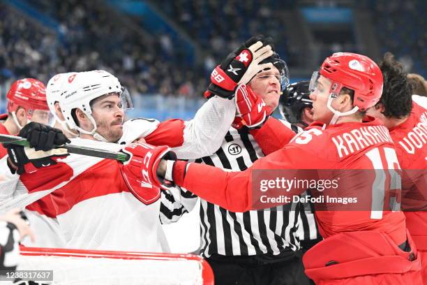 Raphael Diaz of Switzerland and Pavel Karnaukhov of Russia fight at the match Men's Preliminary Round - Group B Results - Olympic Ice Hockey - ROC vs...