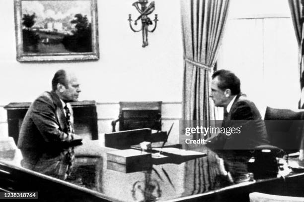 President Richard Nixon talks to Gerald Ford in the Oval Office at the White House, Washington, United States, on August 09, 1974 about the...