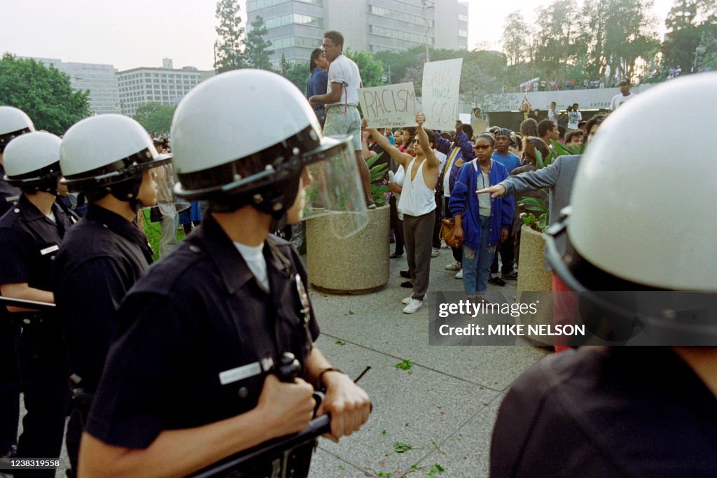 Las Angela's Riot Police officers in riot gear stand by as angry demonstrators gather ...