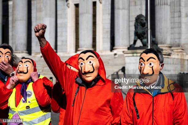 Pensioners wearing red suits and Dali masks of the Spanish Netflix series La Casa de Papel are seen during a protest carried out from the Congress of...