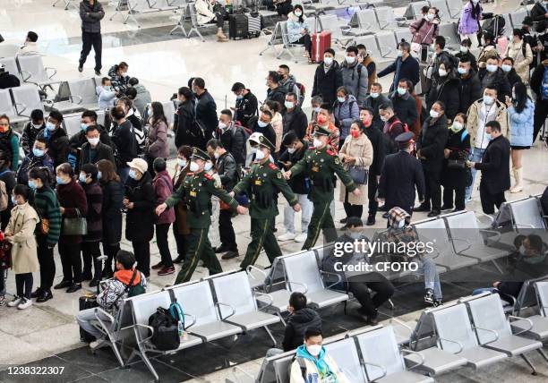 Armed police officers patrol at the waiting hall of Xichang West Railway Station in Xichang, Southwest China's Sichuan Province, February 9, 2022.