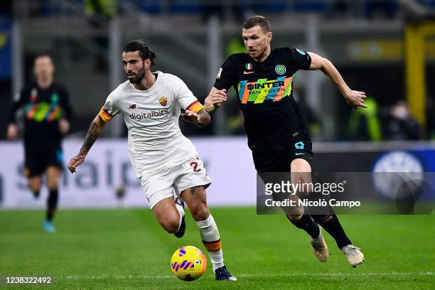 Edin Dzeko of FC Internazionale is challenged by Sergio Oliveira of AS Roma during the Coppa Italia football match between FC Internazionale and AS...