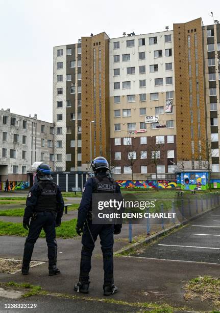 French police officers block the access to a building where No Border activists deployed banners to demand "dignified" housing for all and "freedom...