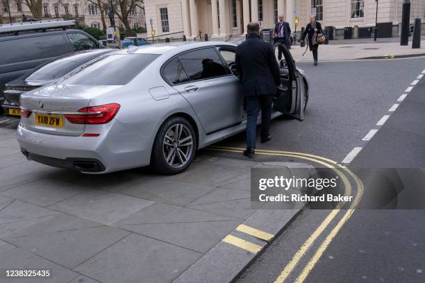 Motorist is seen with a badly-parked BMW car, reversed across a double-yellow line and the kerb and on to the pavement, on the corner of Pall Mall in...