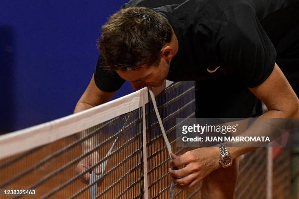 Argentine tennis player Juan Martin Del Potro hangs his headband and kisses it over the net after loosing to Argentine Federico Delbonis during the...
