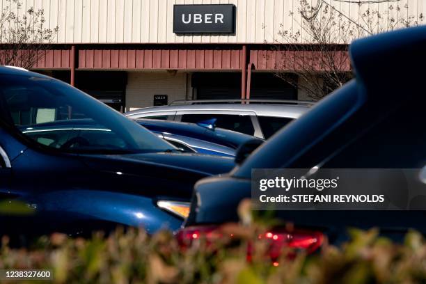 Sign for Uber is displayed above an Uber Greenlight location in Washington, DC, on February 9, 2022. - Uber announced $892 million in quarterly...