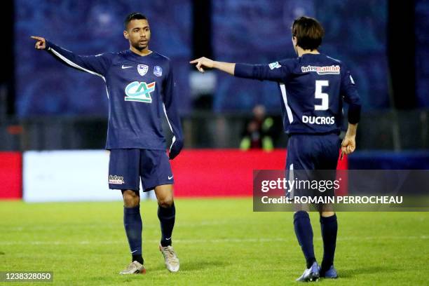 Bergerac's French forward Adrian Sahibeddine and Bergerac's French defender Sam Ducros gesture during the French Cup quarter-final football match...