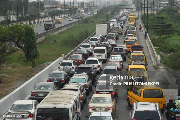 Motorist queue to buy fuel in short supply resulting in traffic gridlock following the discovery of contaminated fuel in supply in filling stations...