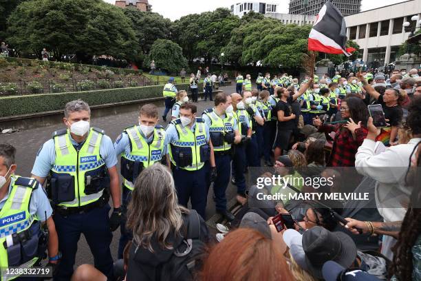 Police move in to evict mandate protesters in parliament grounds in Wellington on February 10 on the third day of demonstrations against Covid-19...