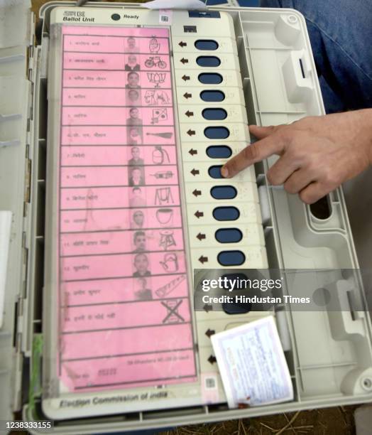 Polling officials are seen with Electronic Voting Machines on the eve of the first phase of UP Assembly elections, at Kamla Nehru Nagar ground on...