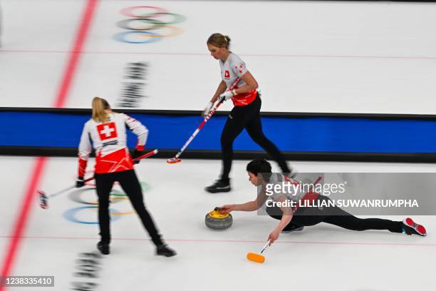 Switzerland's Esther Neuenschwander curls the stone during the women's round robin session 2 game of the Beijing 2022 Winter Olympic Games curling...