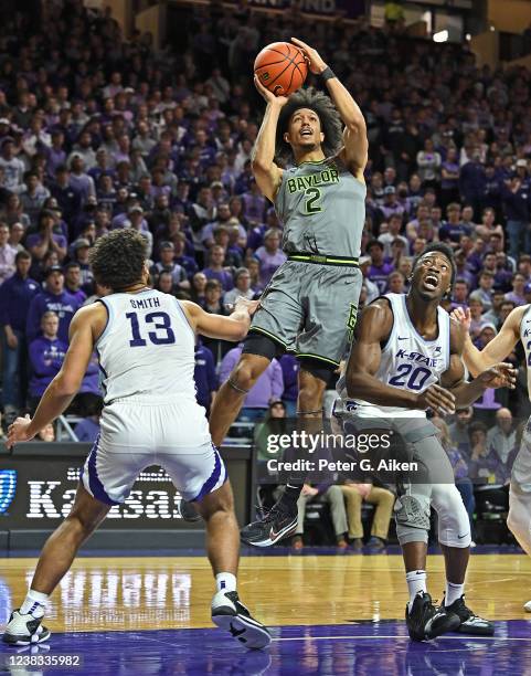 Kendall Brown of the Baylor Bears takes a shot against Mark Smith and Kaosi Ezeagu of the Kansas State Wildcats, during the first half against the...
