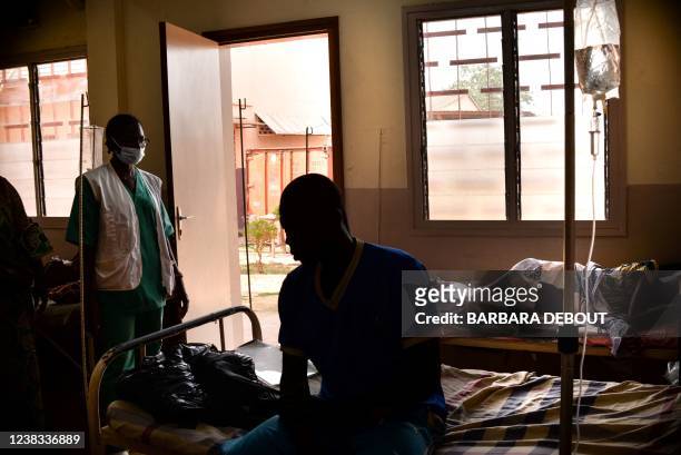 Patient with advanced of Acquired Immunodeficiency Syndrome requiring extensive therapy sits on his bed at the community hospital in Bangui,on...