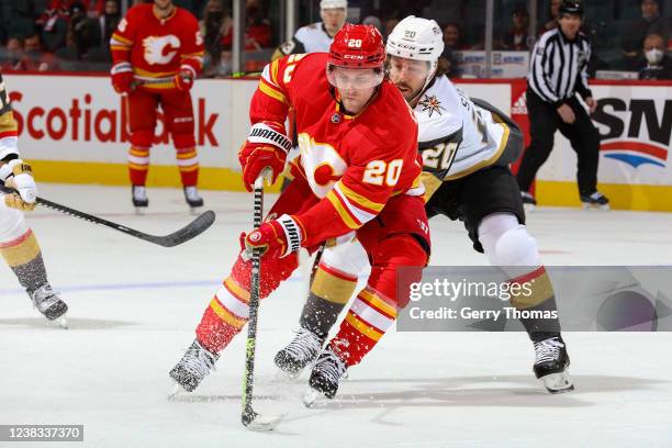 Blake Coleman of the Calgary Flames protects the puck against Chandler Stephenson of the Vegas Golden Knights at Scotiabank Saddledome on February 9,...