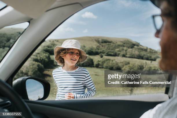 boy looking in car window - summer driving stock pictures, royalty-free photos & images