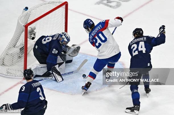 Slovakia's Juraj Slafkovsky scores past Finland's goaltender Harri Sateri during the men's preliminary round group C match of the Beijing 2022 Winter...