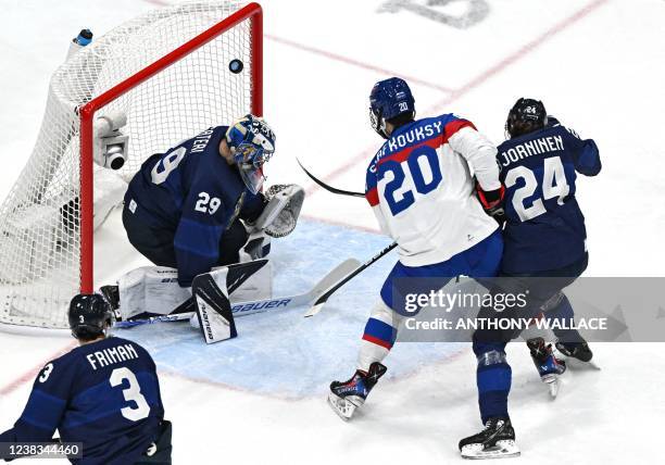 Slovakia's Juraj Slafkovsky scores past Finland's goaltender Harri Sateri during the men's preliminary round group C match of the Beijing 2022 Winter...