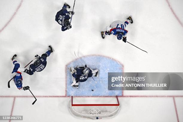 Slovakia's Juraj Slafkovsky scores past Finland's goaltender Harri Sateri during the men's preliminary round group C match of the Beijing 2022 Winter...