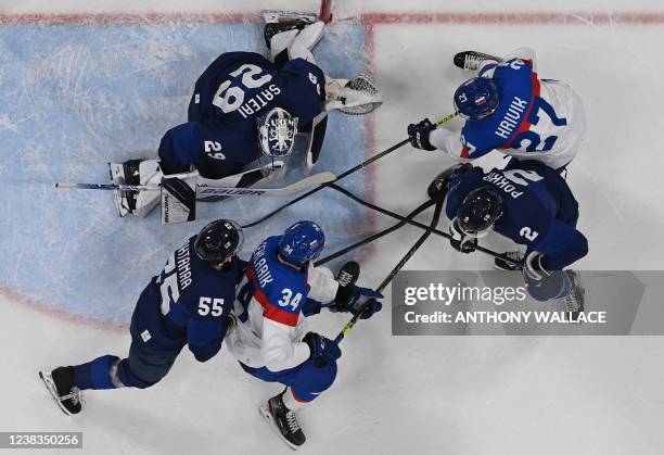 Finland's goaltender Harri Sateri defends his goal during the men's preliminary round group C match of the Beijing 2022 Winter Olympic Games ice...