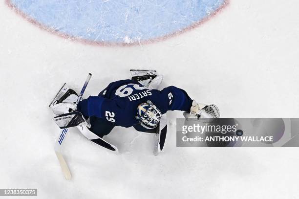 Finland's goaltender Harri Sateri makes a save during their men's preliminary round group C match of the Beijing 2022 Winter Olympic Games ice hockey...