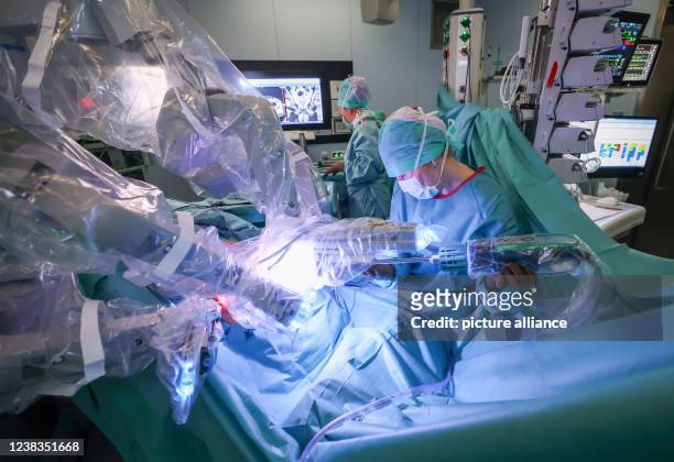 February 2022, Schleswig-Holstein, Kiel: A resident and a surgical nurse work during a robot-assisted prostate surgery at the University Hospital...