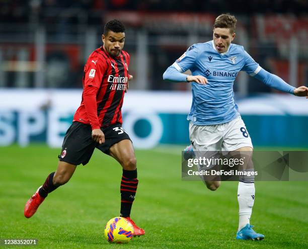 Junior Messias of AC Milan and Toma Basic of SS Lazio battle for the ball during the Coppa Italia match between AC Milan and SS Lazio at Stadio...