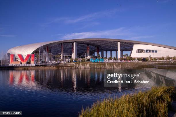 Los Angeles, CA Workers make last minute preparations for the Super Bowl as viewed from the lake at SoFi Stadium in Los Angeles Wednesday, Feb. 9,...