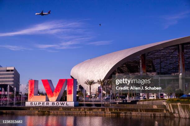 Los Angeles, CA Workers make last minute preparations for the Super Bowl as viewed from the lake at SoFi Stadium in Los Angeles Wednesday, Feb. 9,...