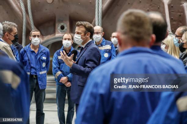 French President Emmanuel Macron talks to officials and workers at the GE Steam Power System main production site for its nuclear turbine systems in...
