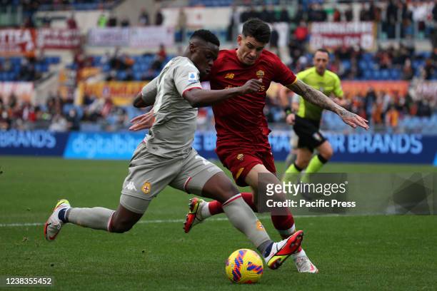 Caleb Ekuban and Roger Ibanez compete for the ball during the Serie A match between AS Roma and Genoa Cricket and Football Club at Stadio Olimpico....