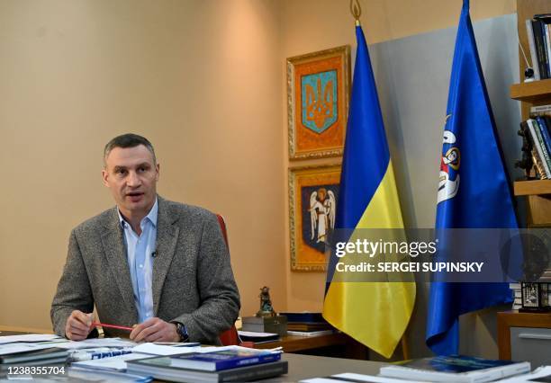 Heavyweight boxing champion, turned Kyiv mayor Vitali Klitschko, talks to AFP journalists at his office in Kyiv on February 10, 2022. - Vitali...