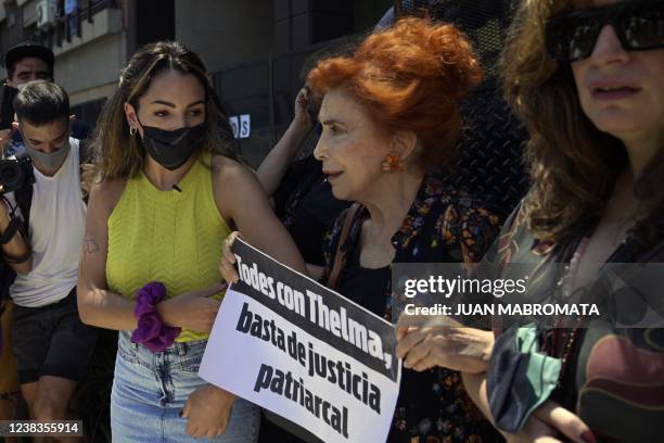 Argentine actress Mirta Busnelli holds a sign reading "All with Thelma, enough of patriarchal justice", during a protest outside the Brazilian...