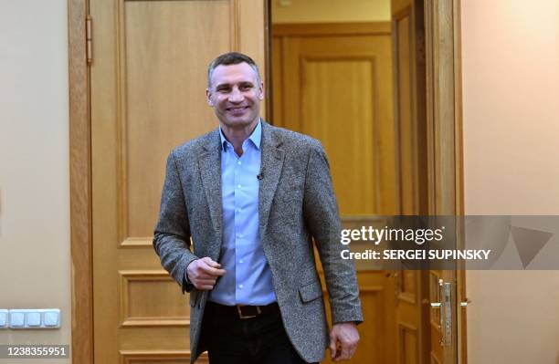 Heavyweight boxing champion, turned Kyiv mayor Vitali Klitschko, smiles as he enters his office prior to an interview in Kyiv on February 10, 2022. -...