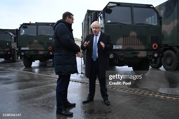 Prime Minister, Boris Johnson speaks with Polish Prime Minister Mateusz Morawiecki during a visit to Warszawska Brygada Pancerna military base on...