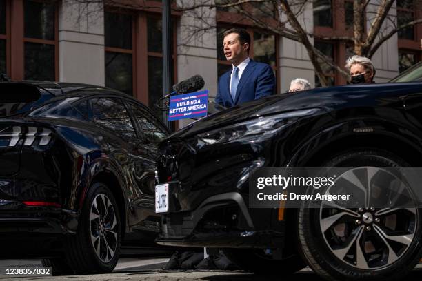 Secretary of Transportation Pete Buttigieg speaks during an event to discuss investments in the U.S. Electric vehicle charging network, outside...