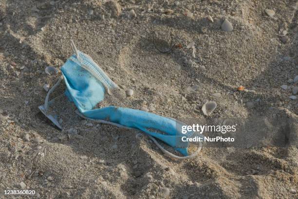 Discarded face mask lies on a beach in Progreso. On Wednesday, February 09 in Progreso, Yucatan, Mexico.