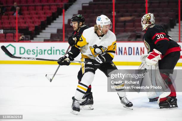 Jeff Carter of the Pittsburgh Penguins prepares battles Josh Brown of the Ottawa Senators in front of Matt Murray at the Canadian Tire Centre on...