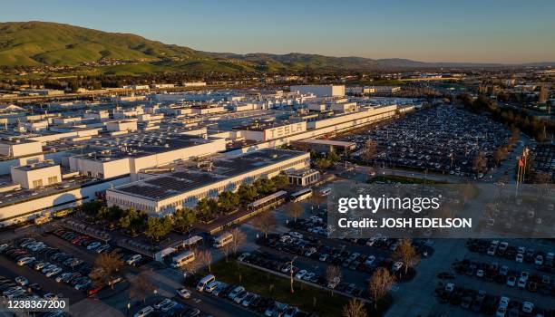 An aerial view shows the Tesla Fremont Factory in Fremont, California on February 10, 2022. - Tesla can hardly make enough electric vehicles to meet...