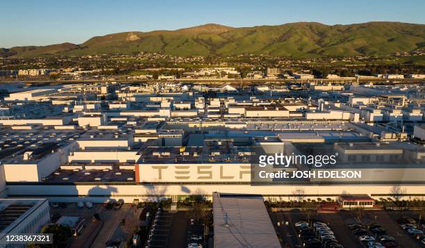 An aerial view shows the Tesla Fremont Factory in Fremont, California on February 10, 2022. - Tesla can hardly make enough electric vehicles to meet...