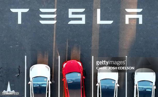 An aerial view shows cars parked at the Tesla Fremont Factory in Fremont, California on February 10, 2022. - Tesla can hardly make enough electric...