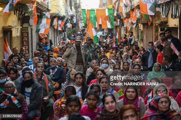 Supporters of India's Congress party listen as party's candidate Navjot Singh Sidhu addresses the gathering during an election campaign for the...