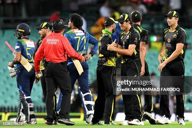 Australia's Pat Cummins shakes hands with teammates after victory in the first T20 international cricket series match between Australia and Sri Lanka...