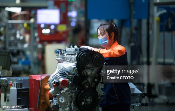 Worker maintains equipment at an engine production workshop in Zhangjiakou city, North China's Hebei Province, Feb 11, 2022. The motor project of the...
