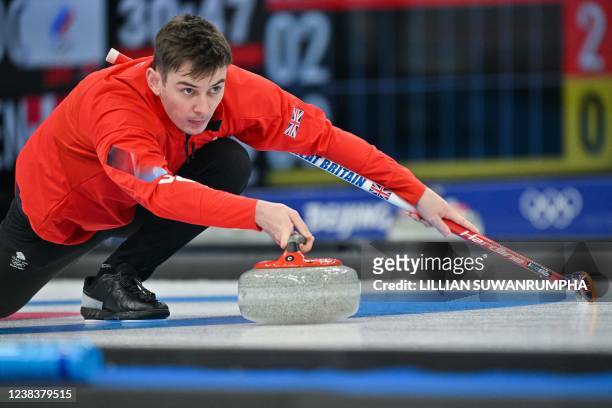 Great Britain's Grant Hardie curls the stone during the mens round robin session 4 game of the Beijing 2022 Winter Olympic Games curling competition...
